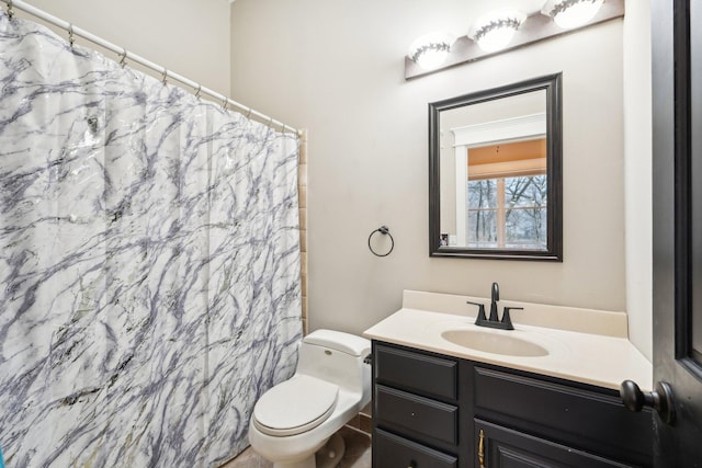 bathroom featuring toilet, a shower with curtain, and vanity