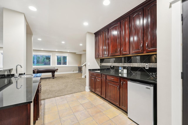 kitchen featuring stainless steel fridge, backsplash, light carpet, sink, and pool table