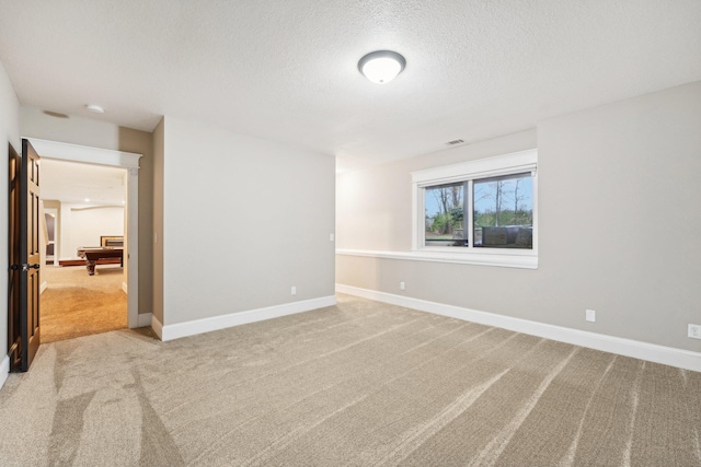 spare room featuring a textured ceiling, carpet flooring, and billiards