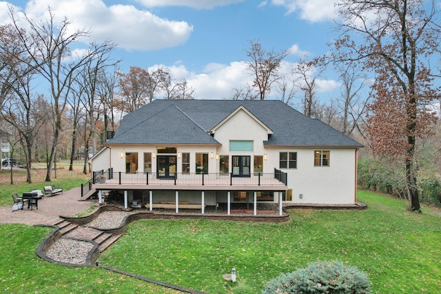 back of property with a lawn and a patio