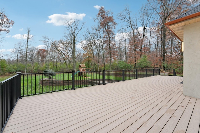 deck with a playground and a yard