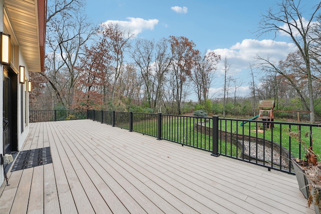 wooden deck with a playground and a yard