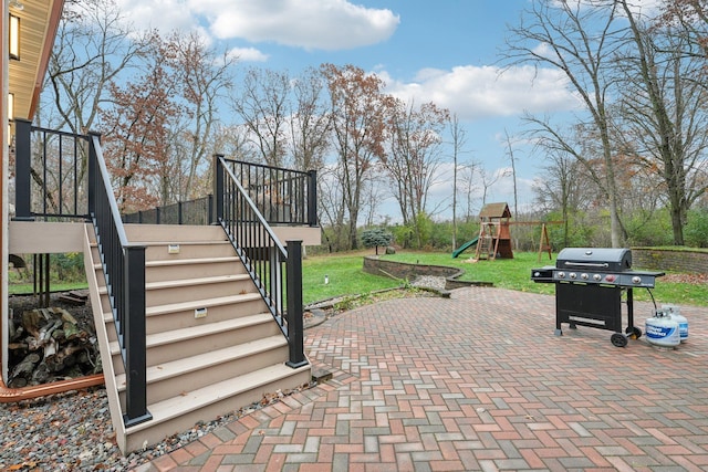 view of patio featuring a playground and area for grilling