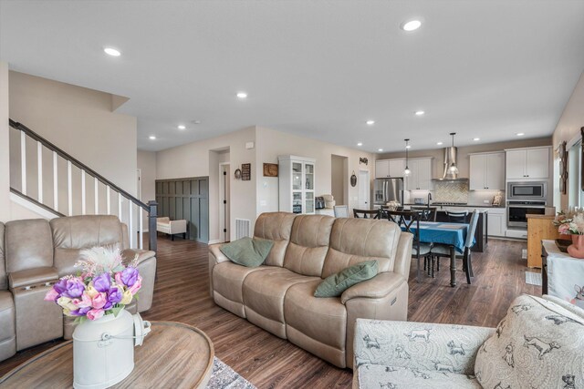 living room with recessed lighting, stairs, and visible vents