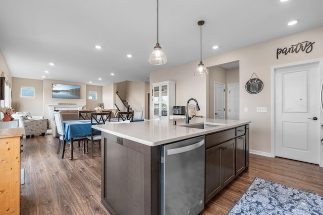 kitchen featuring a sink, dishwasher, light countertops, recessed lighting, and dark wood-style floors