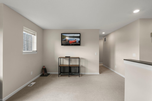 spare room with baseboards, visible vents, and carpet
