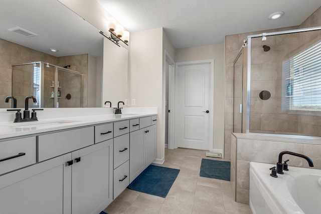 bathroom featuring double vanity, visible vents, a sink, and a stall shower