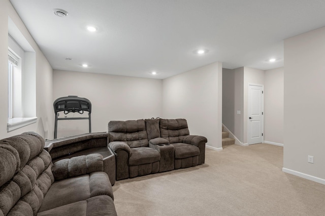 living room featuring recessed lighting, baseboards, stairs, and light carpet