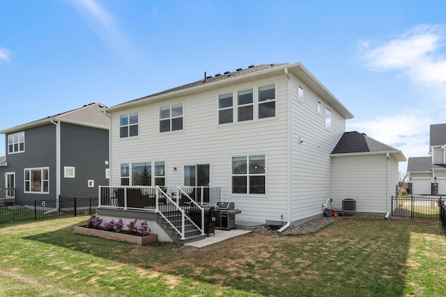 rear view of property with a lawn, a wooden deck, a fenced backyard, and central air condition unit