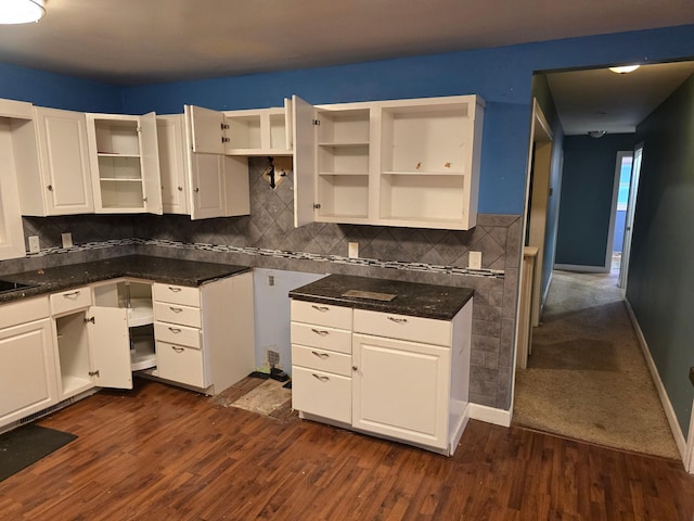 kitchen with white cabinets, dark hardwood / wood-style floors, and tasteful backsplash