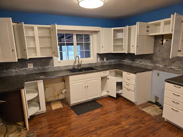 kitchen featuring white cabinets, dark wood-type flooring, sink, and tasteful backsplash