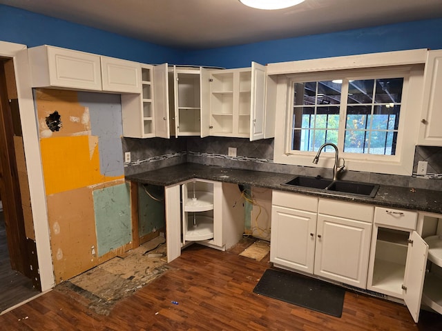 kitchen with tasteful backsplash, sink, dark hardwood / wood-style floors, and white cabinets