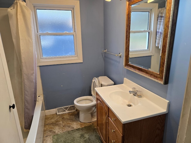 full bathroom with a healthy amount of sunlight, vanity, toilet, and visible vents