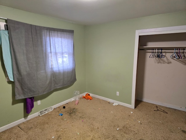 unfurnished bedroom featuring a closet and carpet