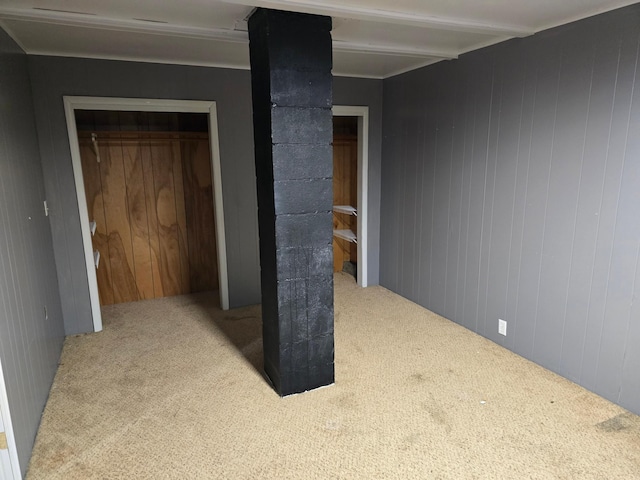 interior space featuring wooden walls and beam ceiling