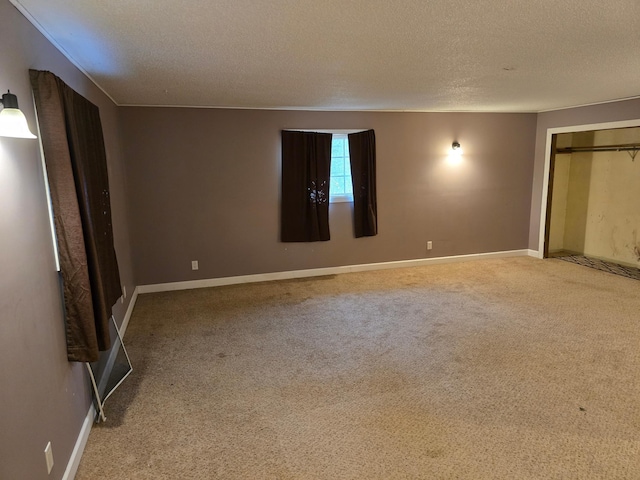 unfurnished bedroom featuring a textured ceiling, a closet, and carpet floors