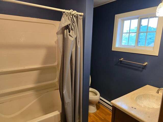 full bathroom with wood-type flooring, vanity, toilet, shower / bath combo with shower curtain, and baseboard heating