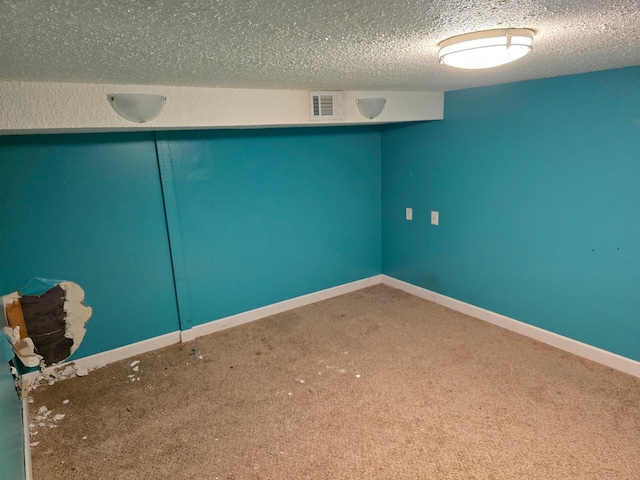 interior space featuring carpet floors and a textured ceiling