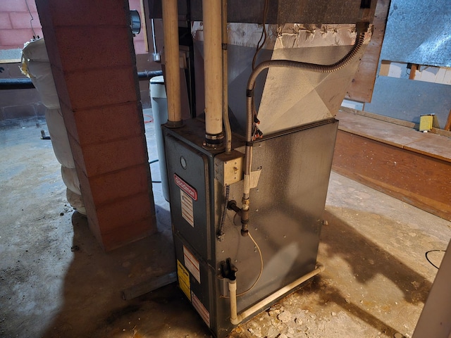 utility room featuring heating unit