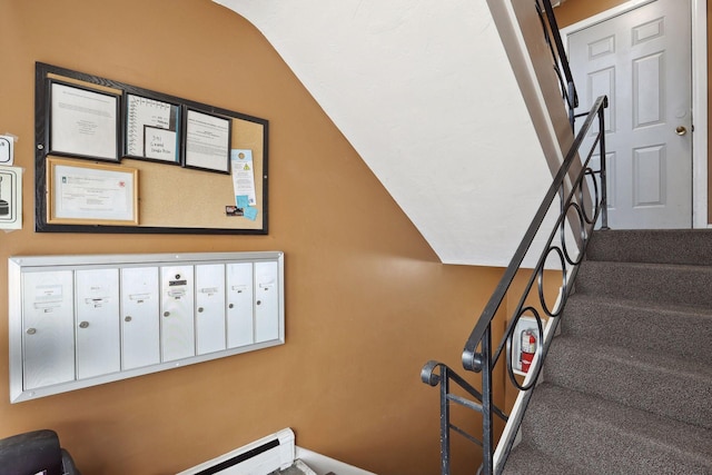 stairway featuring carpet flooring, lofted ceiling, and mail boxes