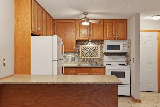 kitchen with kitchen peninsula, backsplash, sink, white appliances, and ceiling fan