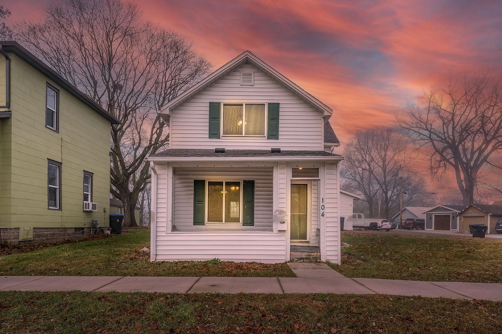 front facade with a yard and a porch