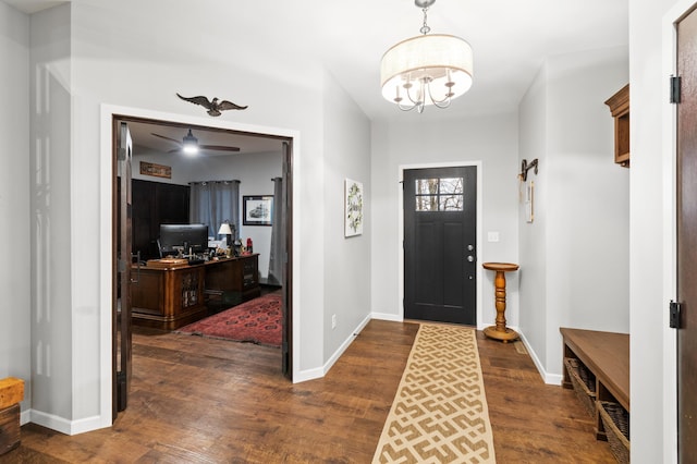 entrance foyer featuring ceiling fan with notable chandelier and dark hardwood / wood-style floors