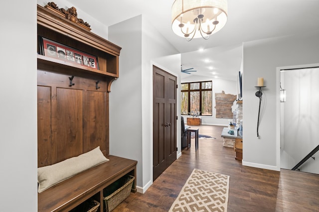 mudroom featuring dark hardwood / wood-style floors, ceiling fan with notable chandelier, and vaulted ceiling