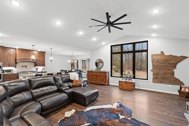 living room featuring dark hardwood / wood-style flooring, ceiling fan with notable chandelier, lofted ceiling, and sink