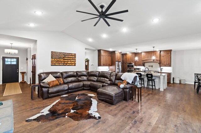 living room with lofted ceiling, ceiling fan, and dark hardwood / wood-style floors