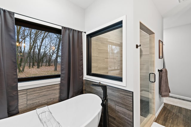 bathroom featuring a bathing tub, plenty of natural light, and hardwood / wood-style floors