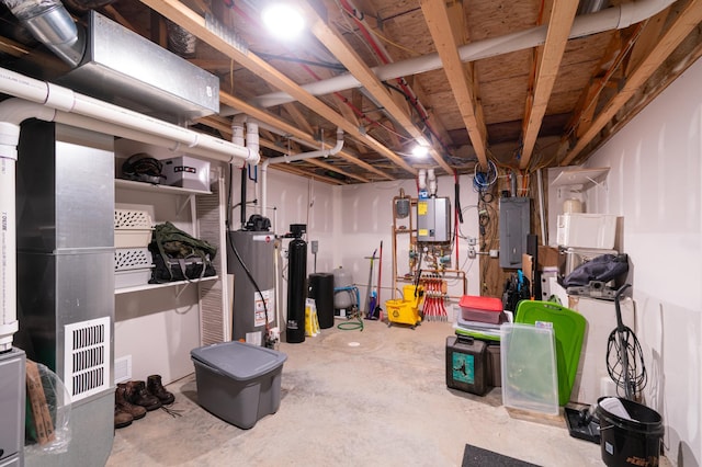 basement featuring electric panel and water heater