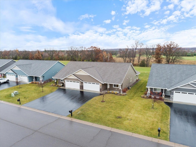 view of front facade featuring a garage and a front lawn