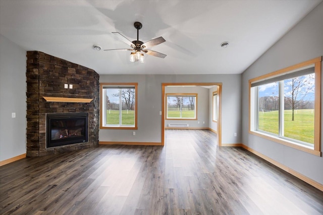 unfurnished living room featuring hardwood / wood-style floors, a wealth of natural light, and lofted ceiling