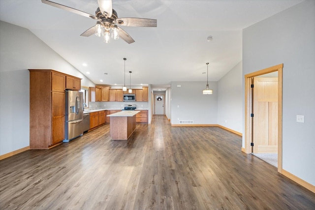 kitchen with stainless steel appliances, dark hardwood / wood-style flooring, pendant lighting, ceiling fan, and a center island