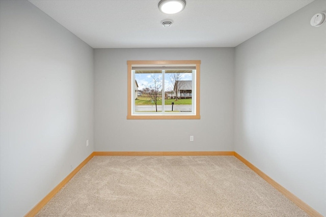 spare room with light colored carpet