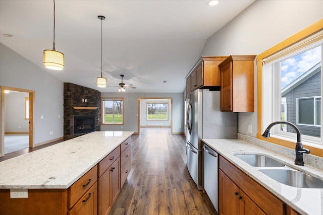 kitchen with dishwasher, sink, pendant lighting, and vaulted ceiling