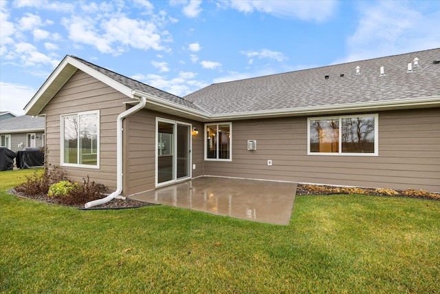 rear view of house with a patio and a yard