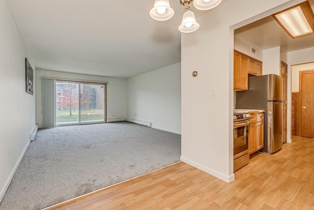 unfurnished living room featuring light hardwood / wood-style floors and baseboard heating