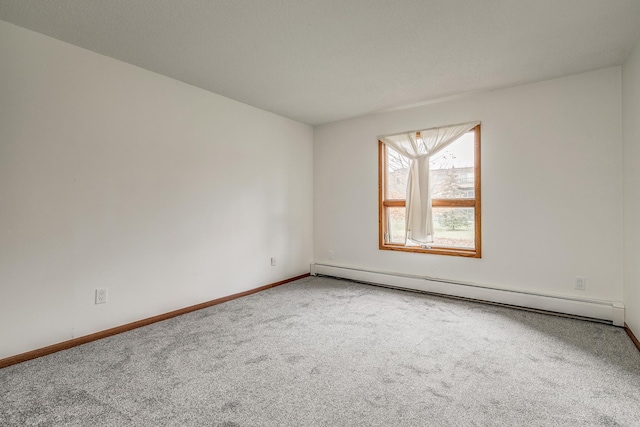 unfurnished room with carpet and a baseboard radiator