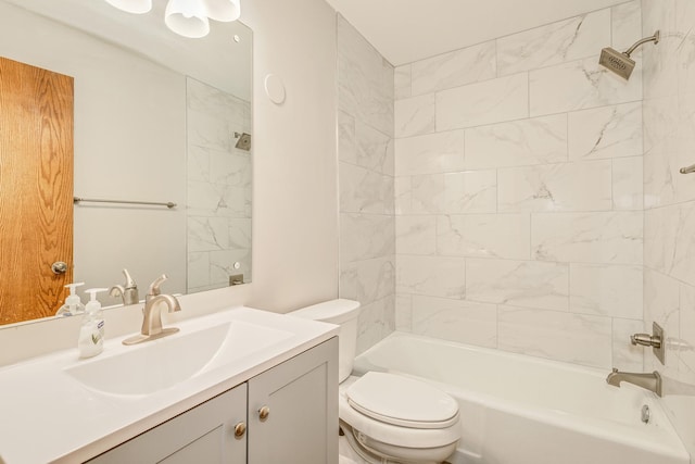 full bathroom with toilet, vanity, and tiled shower / bath