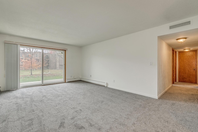 carpeted spare room with a baseboard radiator