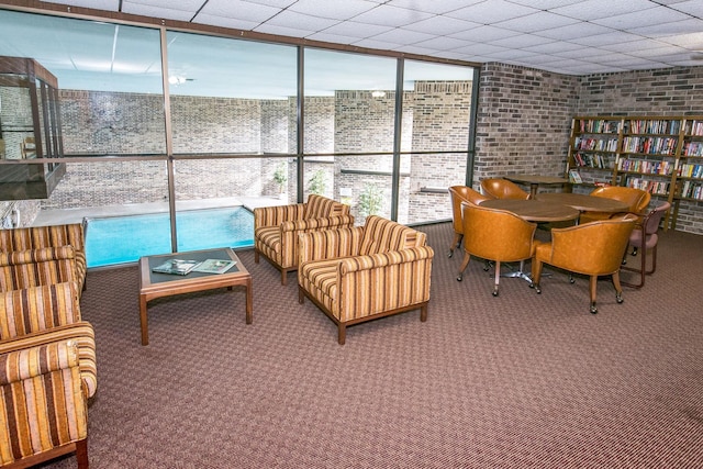 sunroom featuring a paneled ceiling