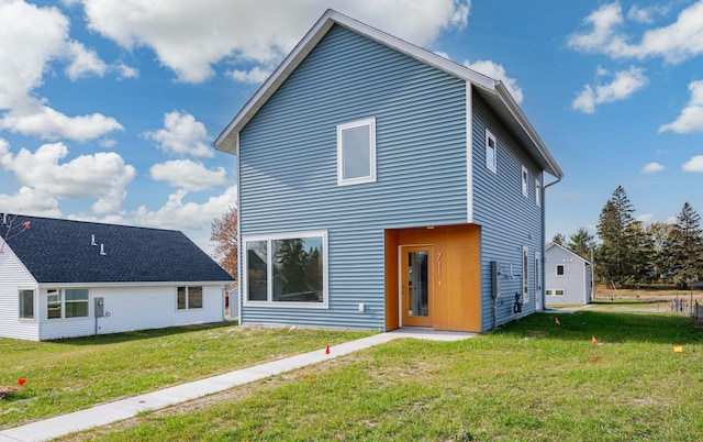 rear view of property with a lawn