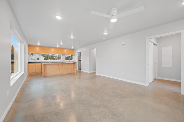 unfurnished living room featuring ceiling fan