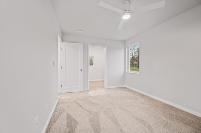 carpeted empty room featuring ceiling fan