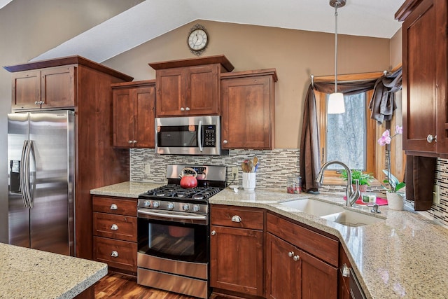 kitchen featuring a sink, vaulted ceiling, backsplash, and stainless steel appliances