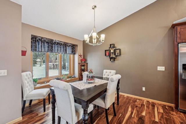 dining room with baseboards, lofted ceiling, an inviting chandelier, and dark wood-style flooring