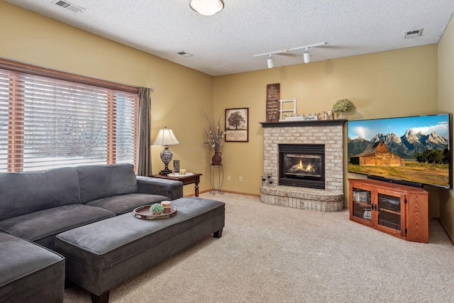 carpeted living room with visible vents and a textured ceiling