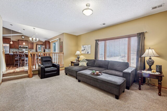 living room with vaulted ceiling, visible vents, and light carpet